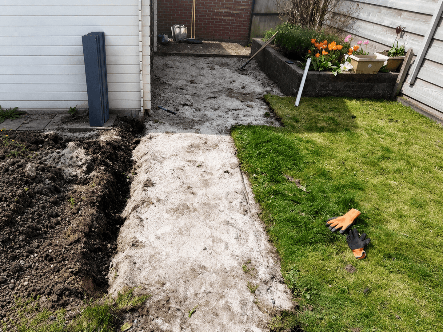 Strip excavated through the lawn in preparation for the new walkway.